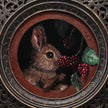 Close-up of bunny eating berries painting inside ornate bronze frame