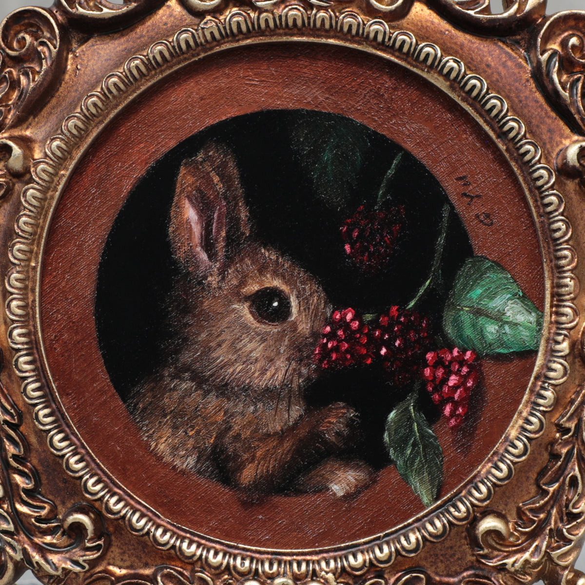 Close-up of bunny eating berries painting inside ornate gilt frame