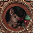 Close-up of bunny eating berries painting inside ornate gilt frame