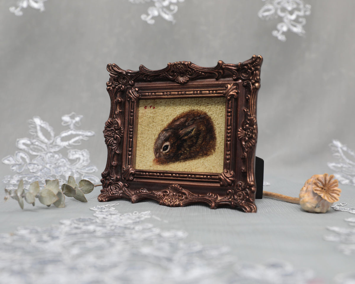 Small framed Cottontail Rabbit painting print in ornate frame, side view