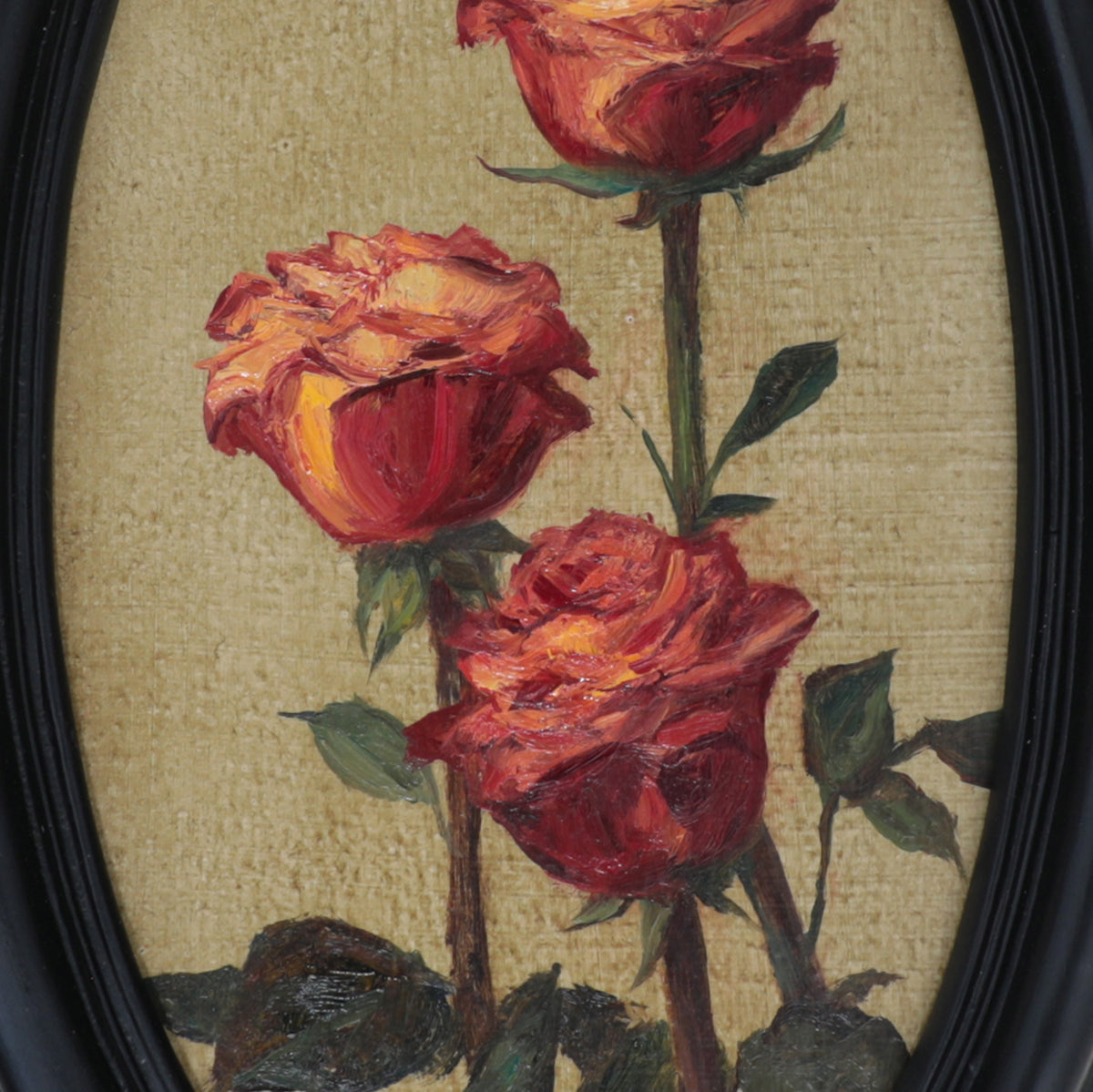 Original red roses oil painting in an ornate long oval gilt frame on cream linen, close up view