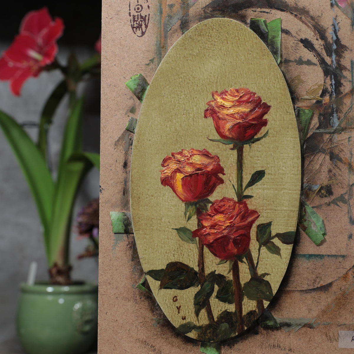 Red rose oil painting on a panel, taped to an easel in the artist's studio