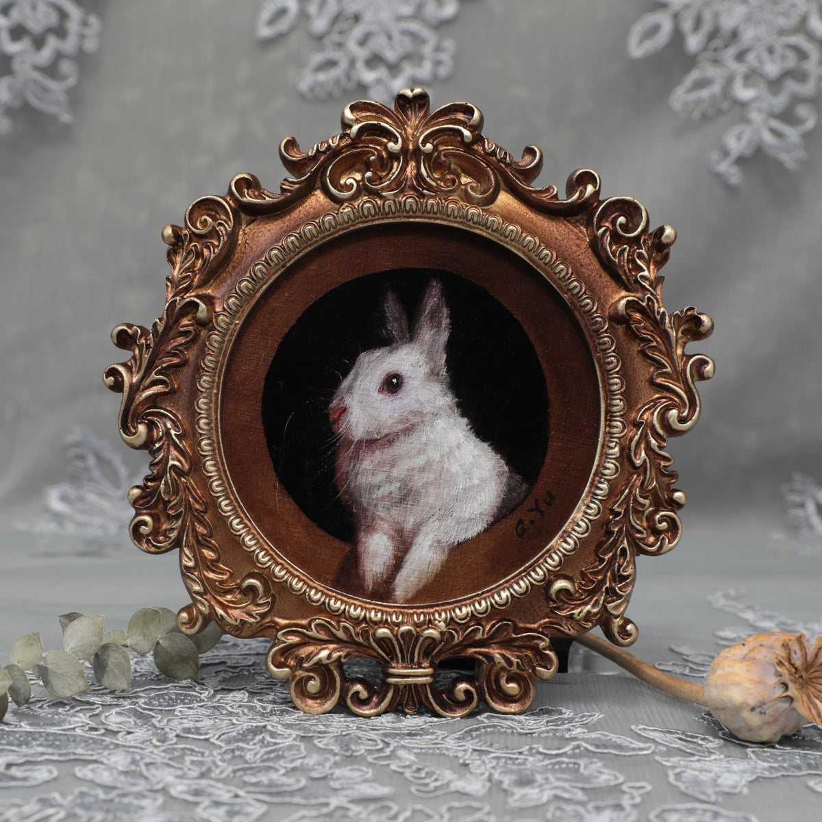 Framed bunny art print in round Baroque gilt frame, front view