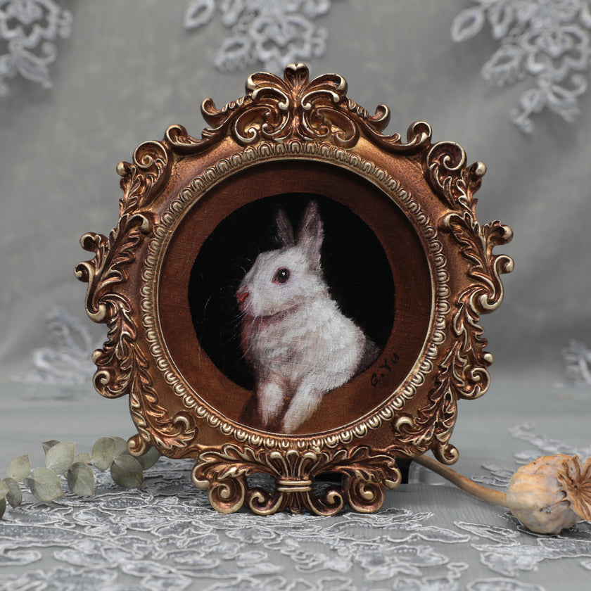 Framed bunny art print in round Baroque gilt frame, front view