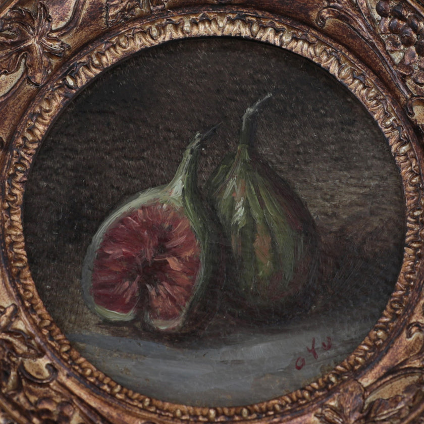 close up of the fig still life oil painting in round gilt frame on cream fabric