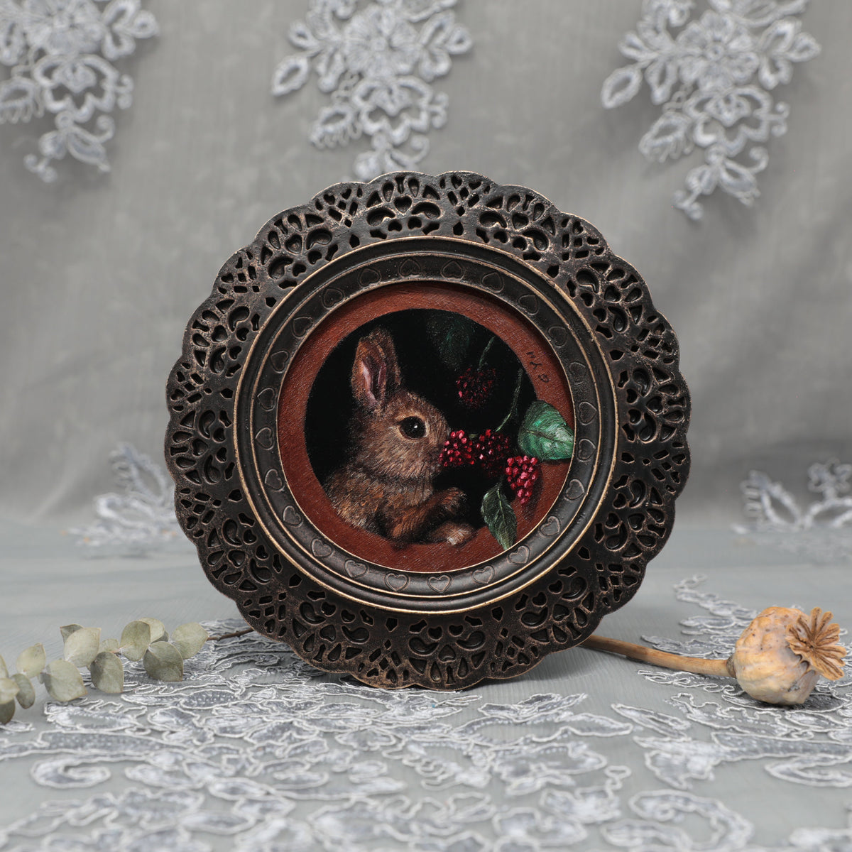 Framed bunny art print in ornate bronze frame standing, front view