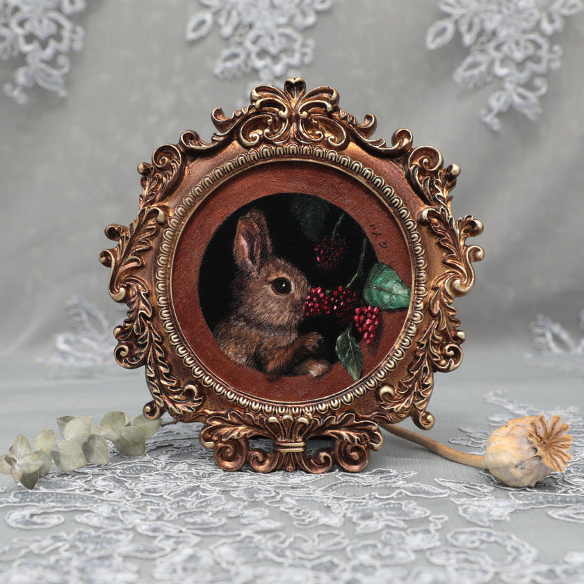 Framed bunny art print in ornate gilt vintaged frame, front view