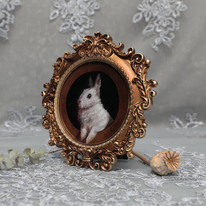 Framed bunny art print in round Baroque gilt frame, side view
