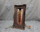 Side angle of long bronze frame with cascading nasturtium print