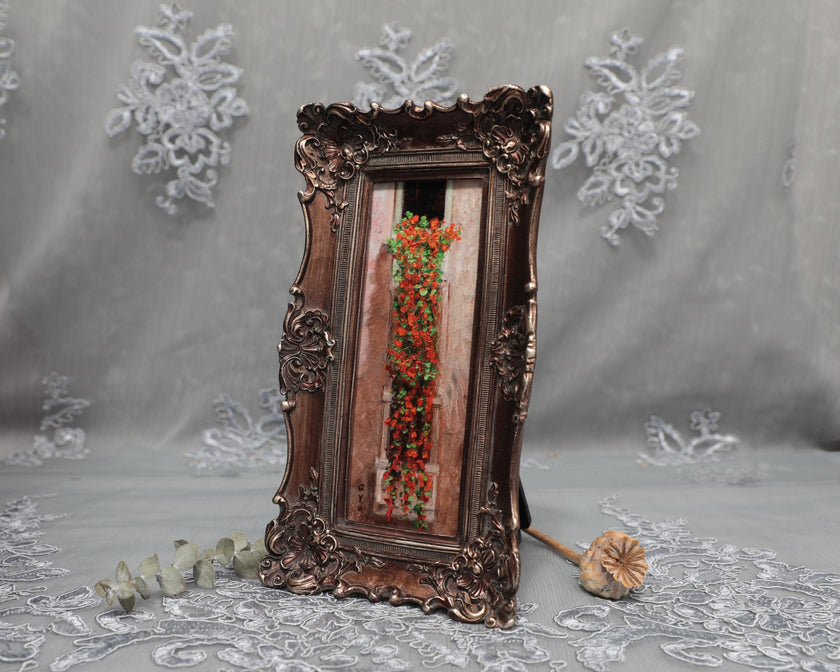 Side angle of long bronze frame with cascading nasturtium print