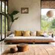 Mockup of the rose oil painting in a bright, modern tropical room with a woven rug, wooden coffee table, and large potted plant.