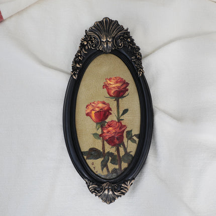 Original red roses oil painting in an ornate long oval gilt frame on cream linen
