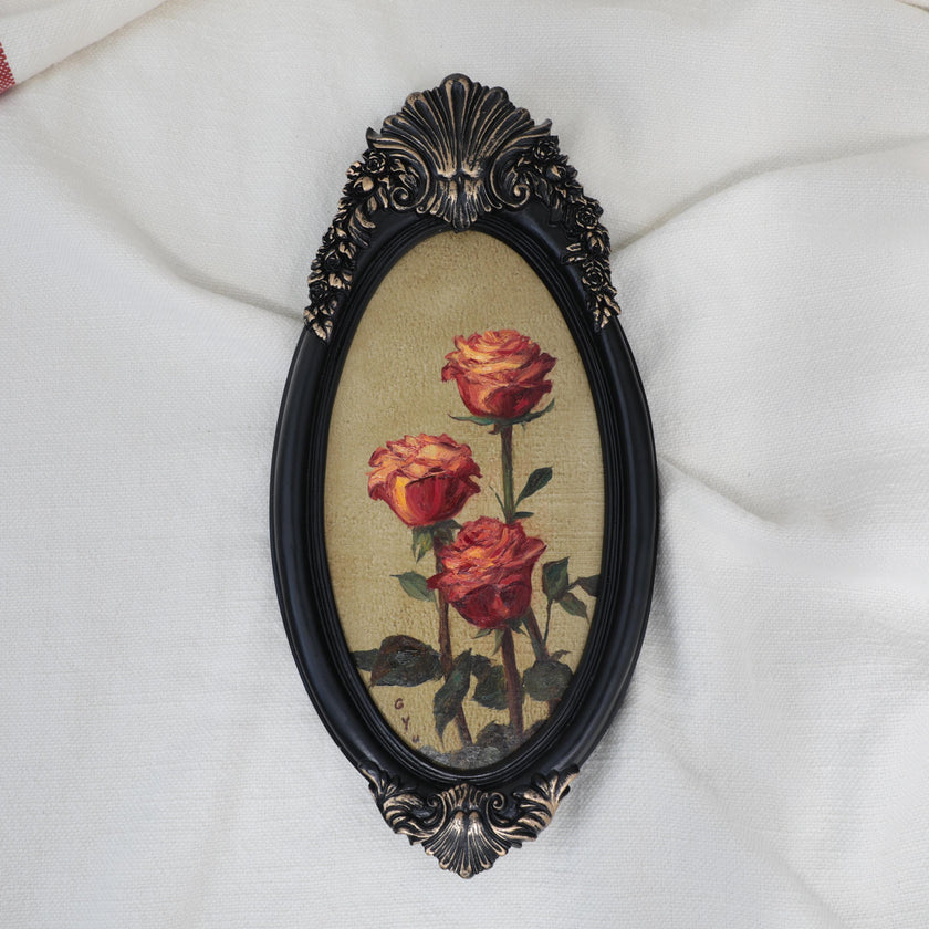 Original red roses oil painting in an ornate long oval gilt frame on cream linen