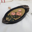 Original pink rose oil painting in an long oval gilt frame on cream line, side view