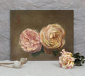Original rose oil painting standing against a wall with dried flowers for scale. 