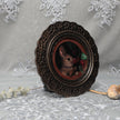 Framed bunny art print in ornate bronze frame standing, side view