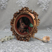 Framed bunny art print in ornate gilt vintaged frame, side view