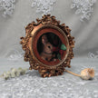 Framed bunny art print in ornate gilt vintaged frame, side view