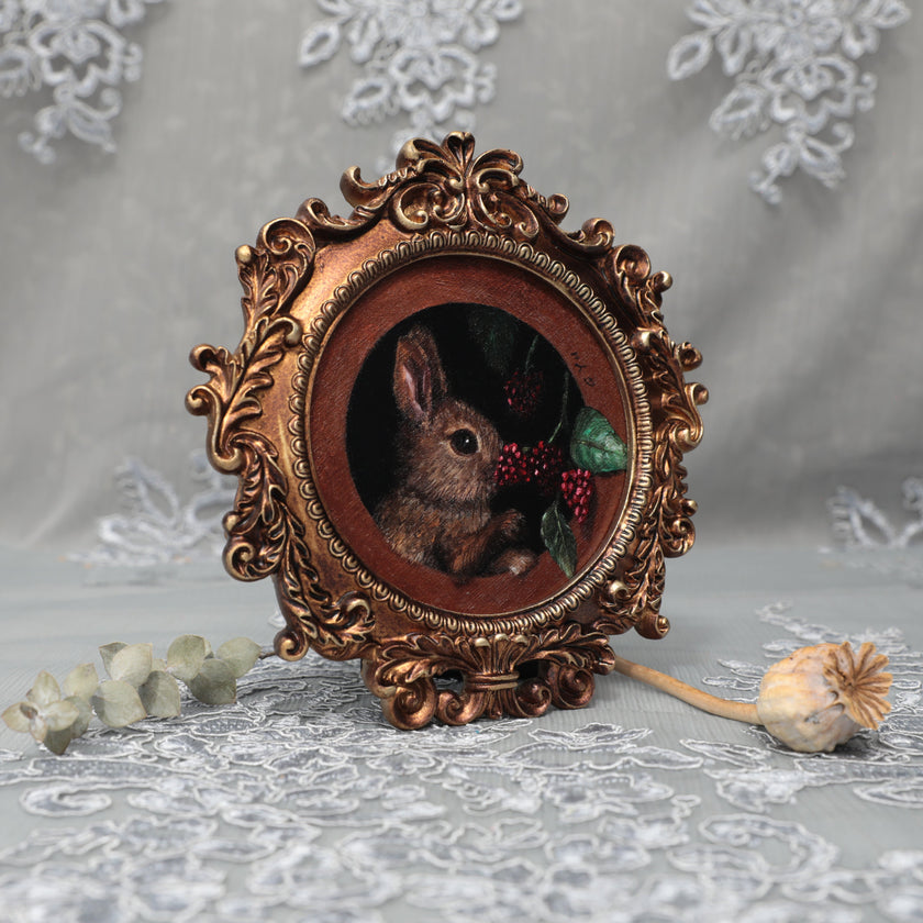 Framed bunny art print in ornate gilt vintaged frame, side view