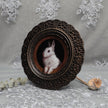 Small framed bunny painting print displayed among dried flowers and lace