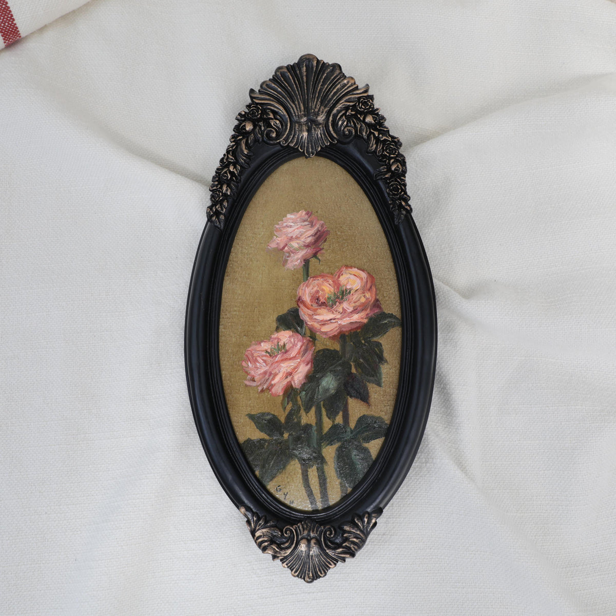Original pink rose oil painting in an long oval gilt frame on cream linen