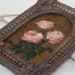 Original pink rose oil painting in arch gilt frame on cream linen, side view close up.