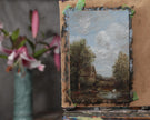 The unframed miniature antique-style landscape painting on the artist easel 
