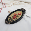 Original red roses oil painting in an ornate long oval gilt frame on cream linen, side view