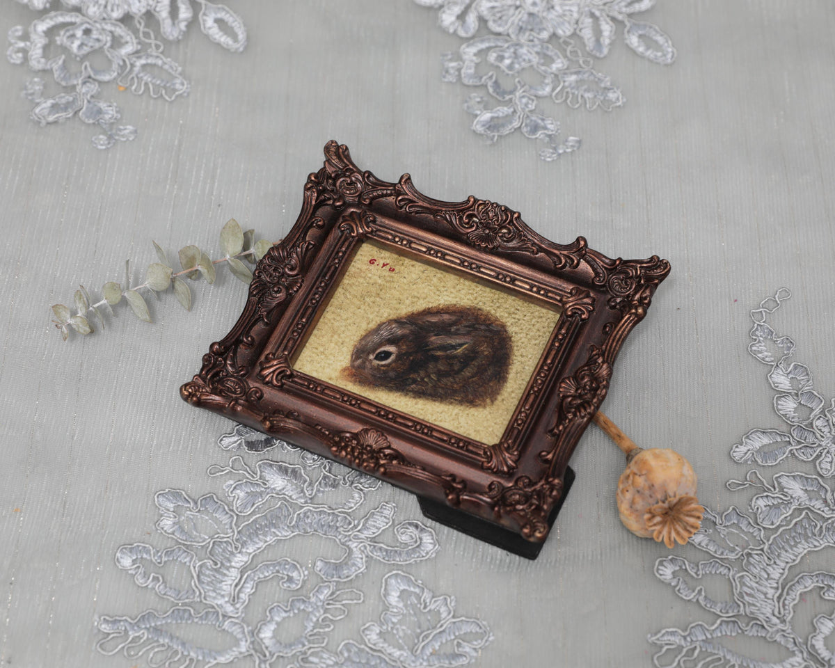 Small framed Cottontail Rabbit painting print in ornate frame, top view