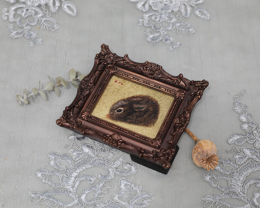 Small framed Cottontail Rabbit painting print in ornate frame, top view