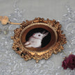 Overhead view of framed bunny art print with dried florals
