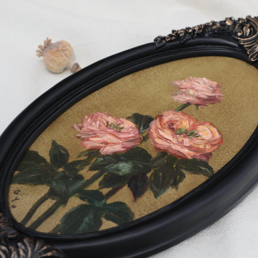 Original pink rose oil painting in an long oval gilt frame on cream linen, side view, close up