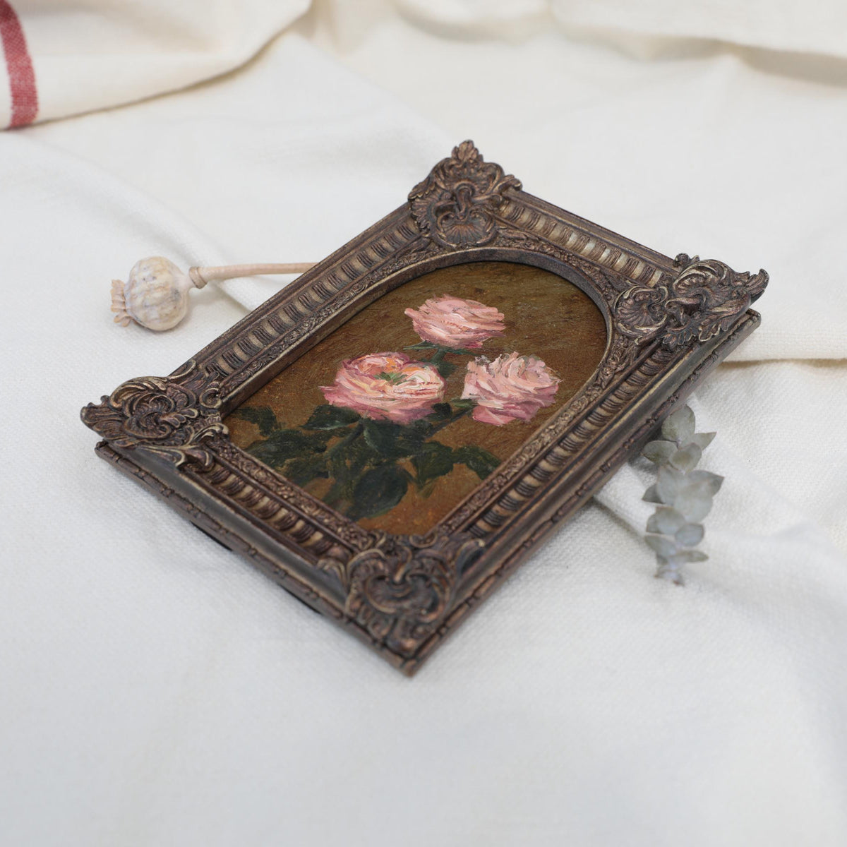 Original pink rose oil painting in arch gilt frame on cream linen, side view