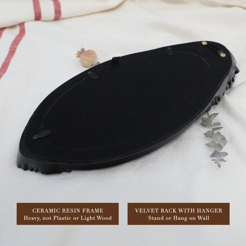 Back of frame showing hanging hardware and velvet-lined backside.