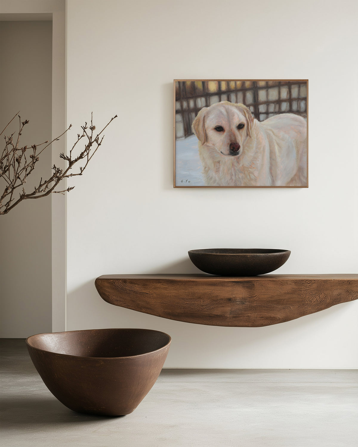 Oil painting of a golden retriever dog hanging on a light beige wall above a floating wooden shelf, with two dark ceramic bowls placed on and below the shelf.