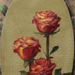 Close up of Red rose oil painting on a panel, taped to an easel in the artist's studio