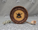 Framed bumblebee art print in ornate bronze frame, standing