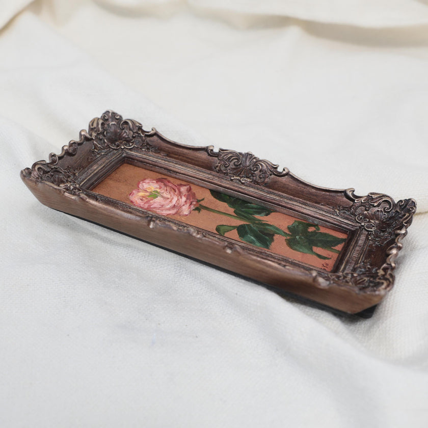 Original pink rose oil painting in an long narrow gilt frame on cream linen, side view