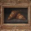 Front view of a two croissants still life oil painting in a vintage-style gilt frame