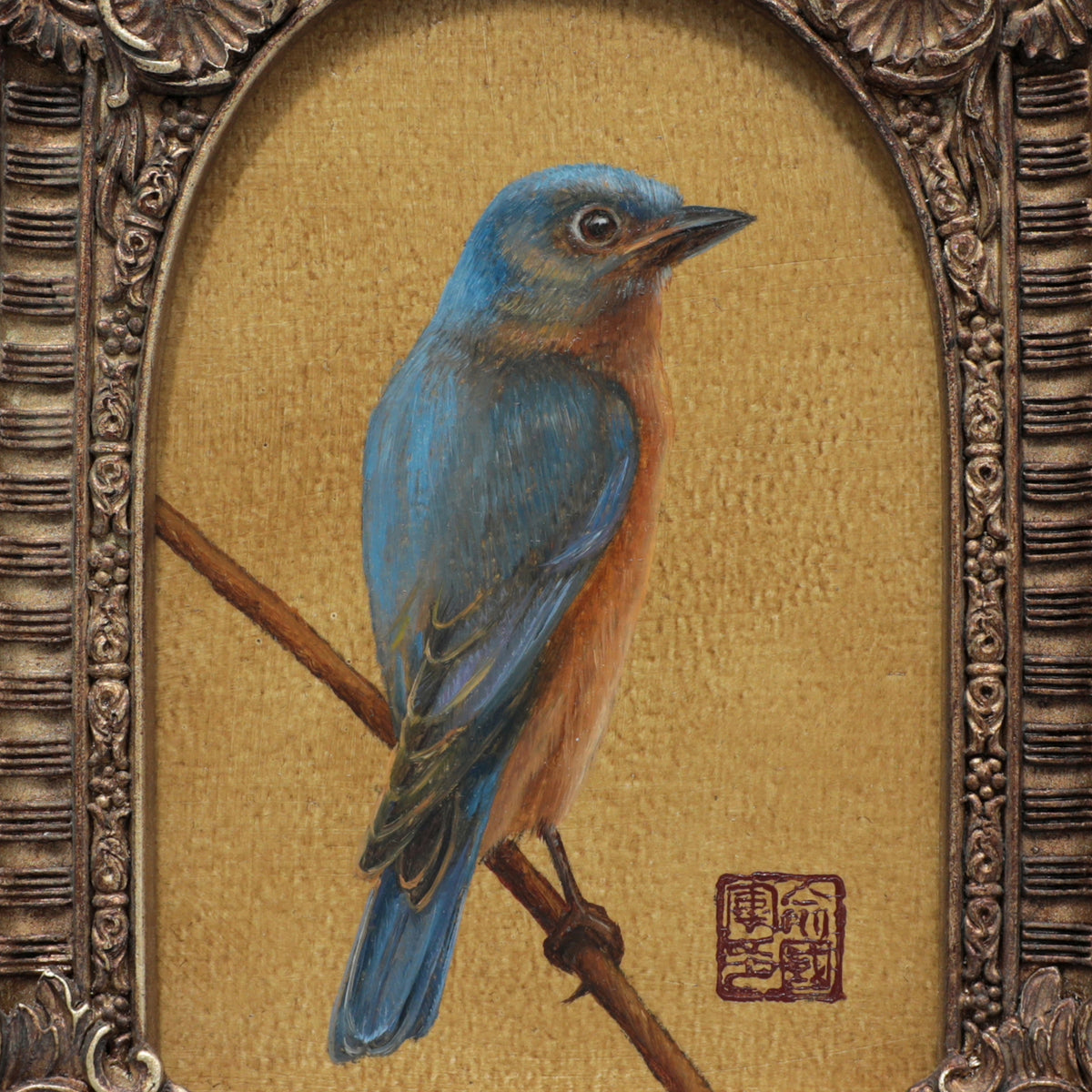 Close up of the framed bluebird art print with arch frame on beige background