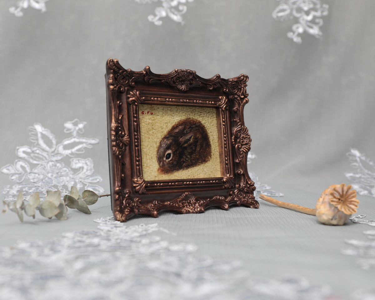Small framed Cottontail Rabbit painting print in ornate frame, side view