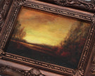 Close-up of sunset landscape oil painting print in ornate bronze frame