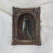 Small still life oil painting of three hanging fish on a dark background in an arched ornate vintage-style frame