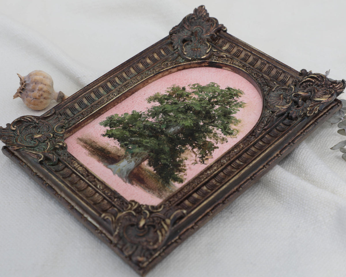 Angled view of an Old Master inspired tree oil painting in a dark bronze ornate frame