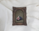 Small framed fig painting in an arched frame with fluted sides and shell corner details